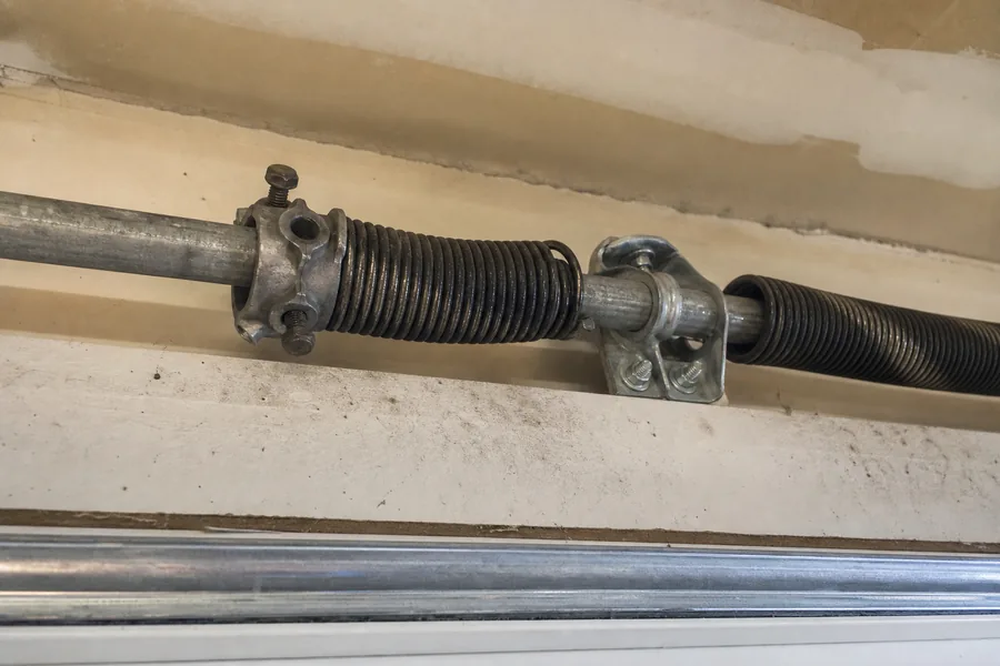 Torsion spring, winding cone and center bearing above a garage door in Meridian, ID